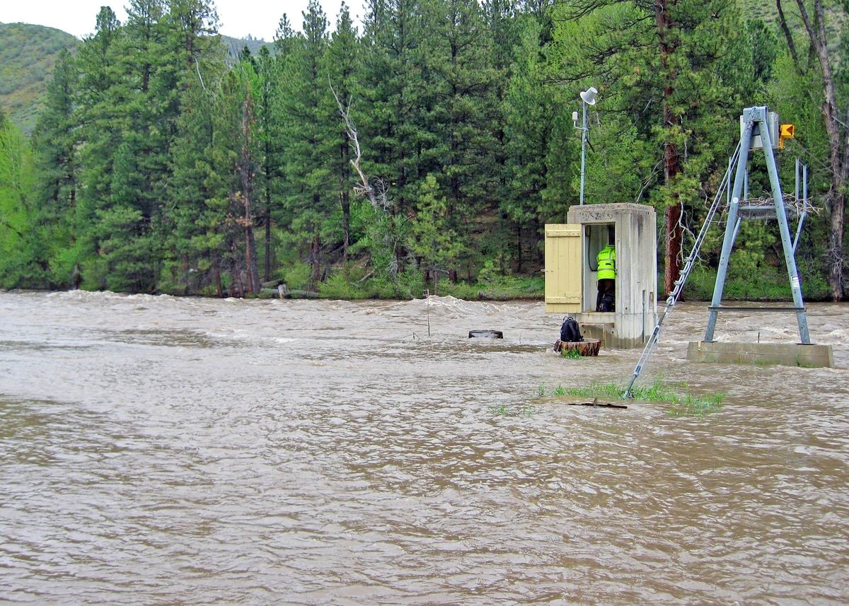 A USGS technician inspects a stream gage on the South Fork Boise River near Featherville Idaho during heavy runoff on May 8