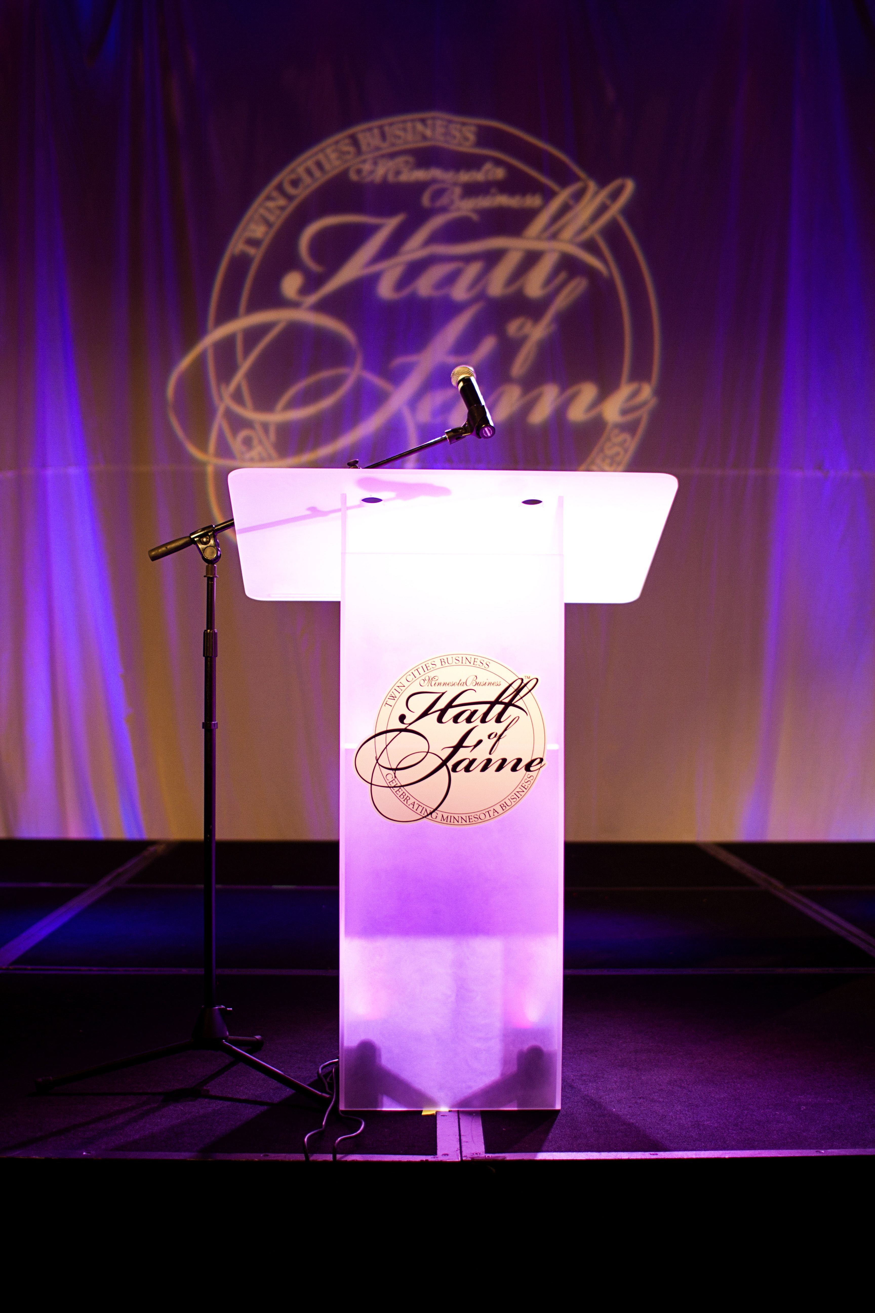 Podium with White Muslin Backdrop and uplighting via AV for You