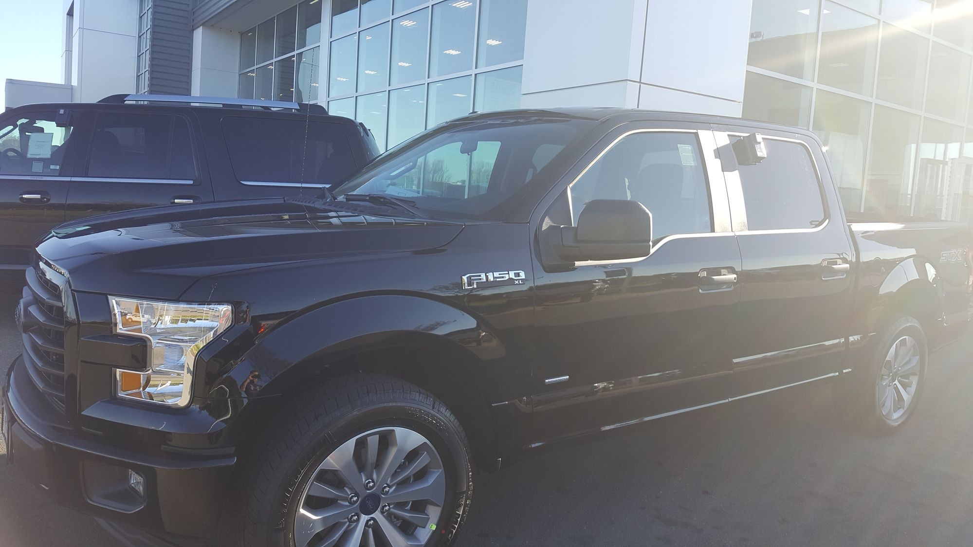 I have the 2017 F150 XL STX package and I absolutely love it It came with power windows locks back up camera rear window defroster sync 3 infotainment